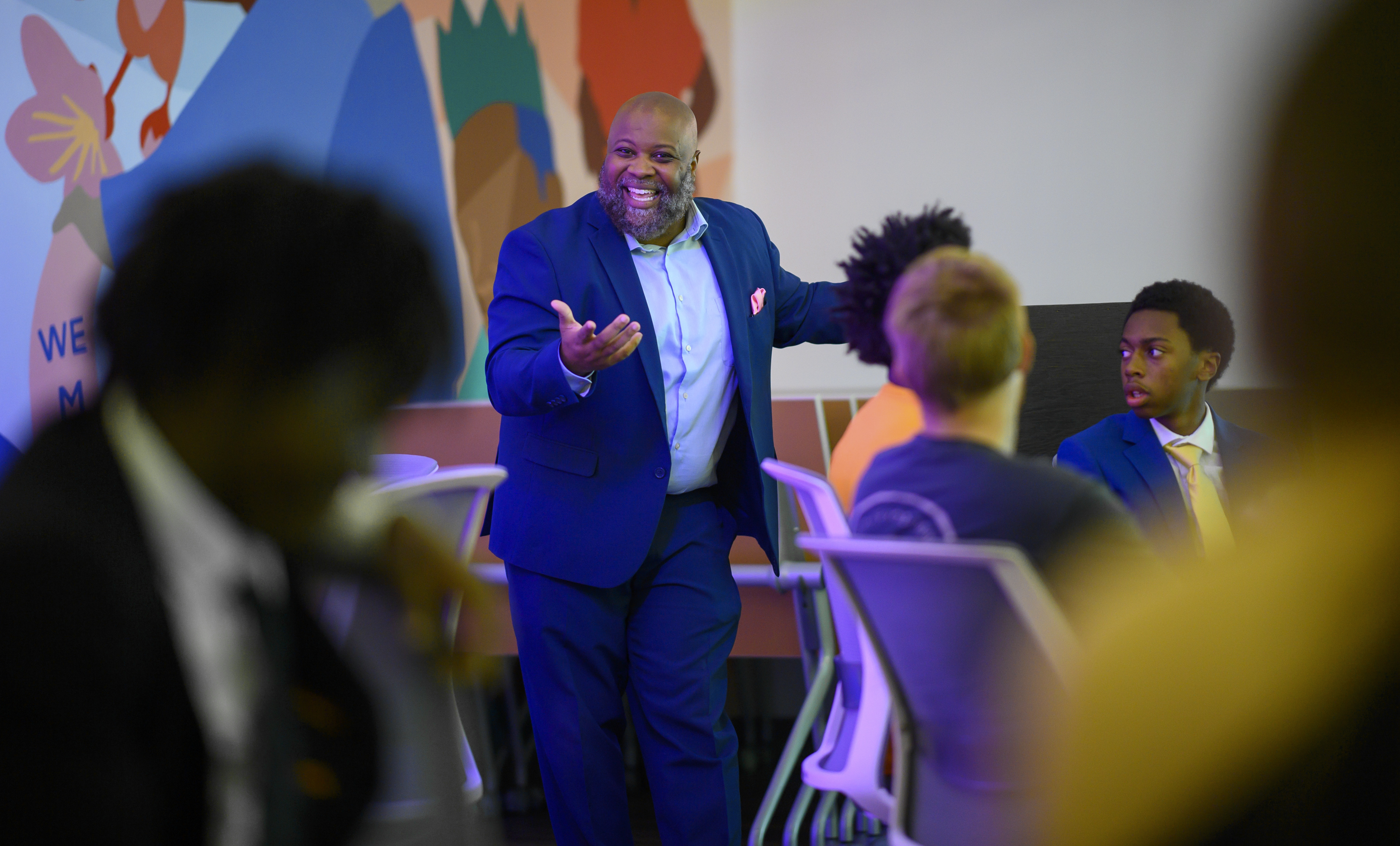 Phillip Edge engaging participants in a group conversation